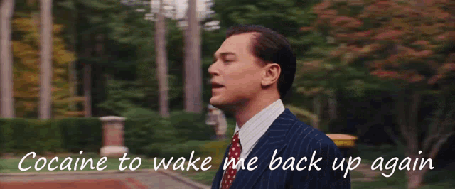 a man in a suit is standing in front of a car with the words " cocaine to wake me back up again " written below him