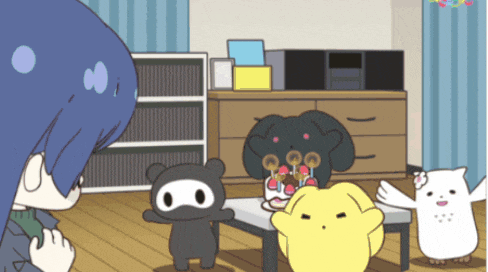 a group of cartoon characters are standing around a table with a cake