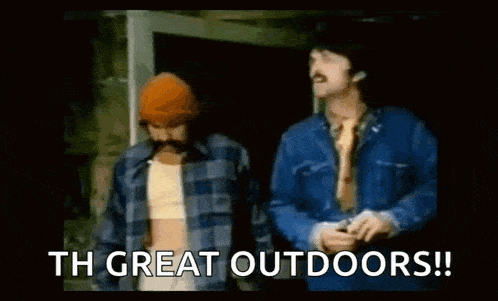 two men are standing next to each other and one of them says `` th great outdoors ! ''