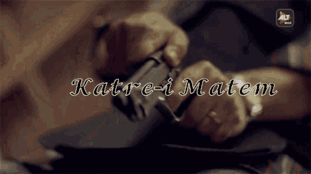 a person holding a gun with the words katre-i matem written above them
