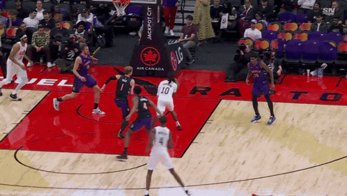 a basketball game is being played in front of a banner that says jackpot city