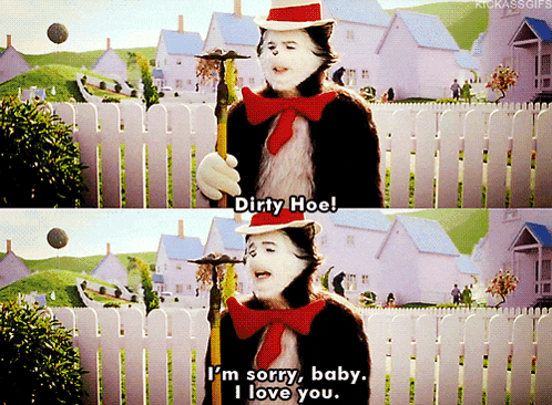 a cat in the hat says " dirty hoe " in front of a white fence