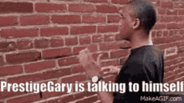 a man is standing in front of a brick wall and talking to himself