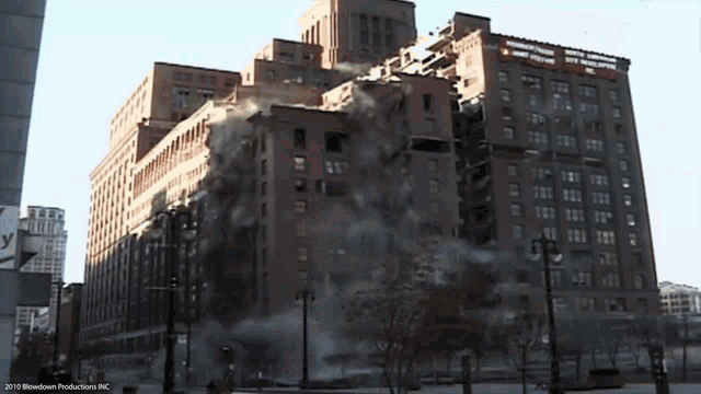 a large brick building is being demolished by blowdown productions