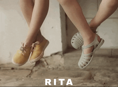 a pair of children 's feet are hanging upside down with the word rita below them