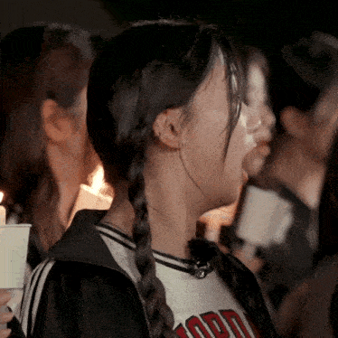 a girl with braids wearing a shirt that says jord