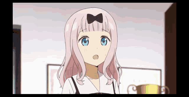 a anime girl with pink hair and blue eyes is standing in a room .