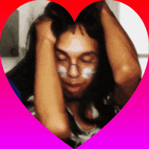 a woman with white paint on her face is surrounded by a heart shaped frame