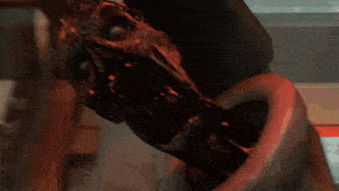 a close up of a monster 's face with a red eye
