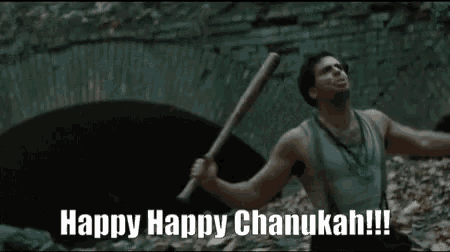 a man is holding a bat and shouting happy happy chanukah !
