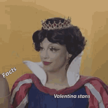 a woman in a snow white costume is wearing a tiara and a red and white dress .