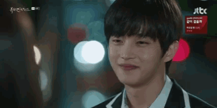 a close up of a man 's face with a blurred background and a jtbc logo in the background .