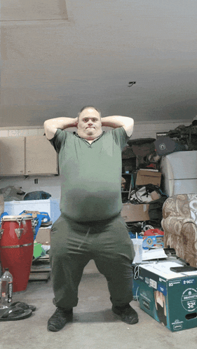 a man squatting in front of a box that says 32 " on it