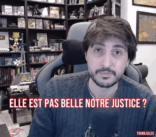 a man sitting in a chair with the words elle est pas belle notre justice written below him