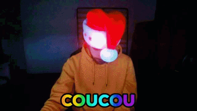 a person wearing a santa hat with the word coucou written on it