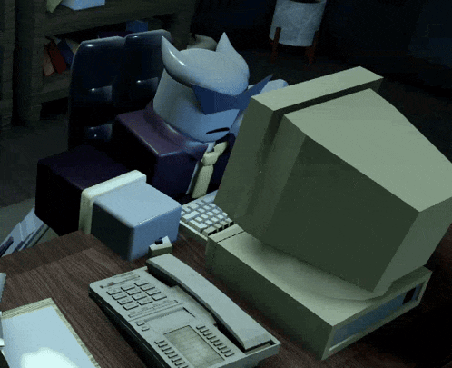 a cartoon character is sitting at a desk with a computer and a phone