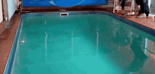 a large indoor swimming pool with a blue cover