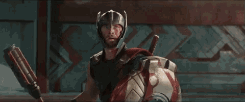 a man in a helmet holding a shield and a sword
