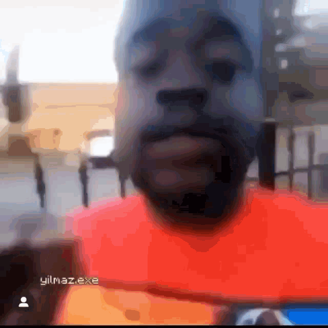 a blurry picture of a man with the name yılmaz.exe written on the bottom