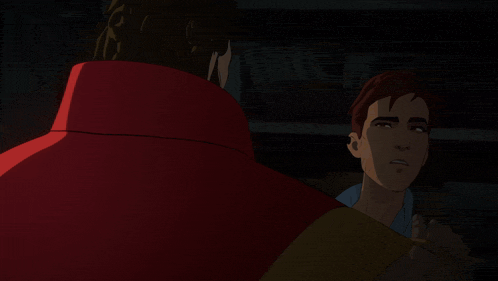 a man is hugging another man in a dark room