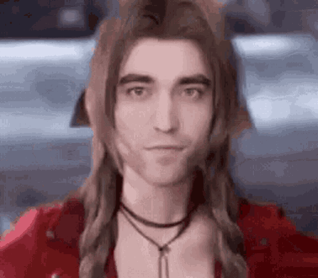 a man with long hair and a braided hairstyle is wearing a red jacket and a necklace .