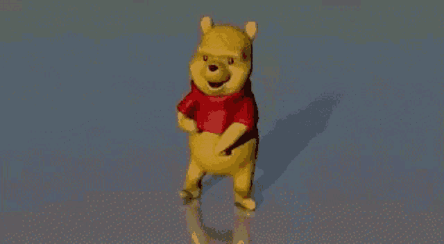 winnie the pooh is wearing a red shirt and dancing on a blue surface .