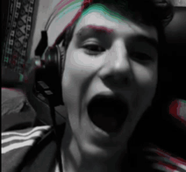 a boy wearing headphones with his mouth wide open