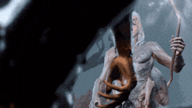 a statue of a woman with long white hair holding a spear
