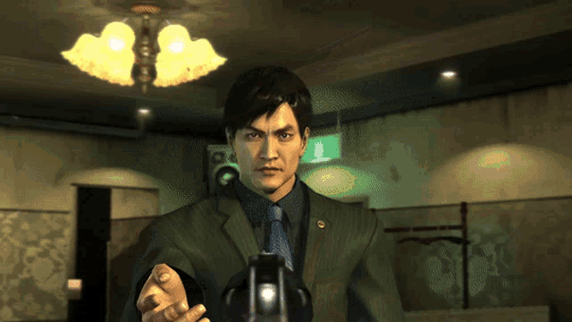 a man in a suit and tie holds a gun in a dark room