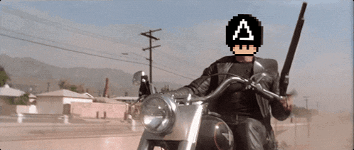 a man is riding a motorcycle with a pixelated a on his head