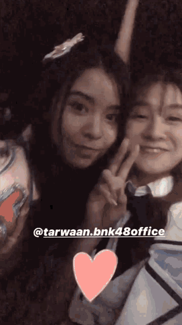 two girls are posing for a picture with the name tarwaan.bnk48office