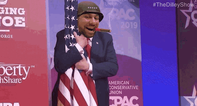 a man is smoking a cigar in front of a sign that says pac