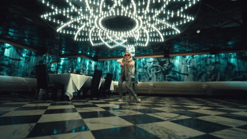 a man stands in a room with a checkered floor