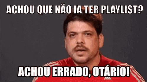 a man wearing a red adidas shirt is making a funny face