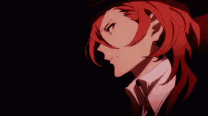 a close up of a person with red hair wearing a top hat and tie .
