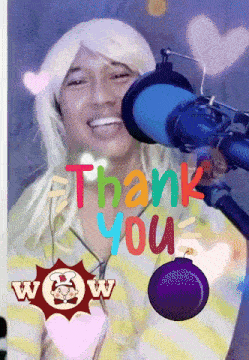 a man wearing a blonde wig stands in front of a microphone with the words thank you above him