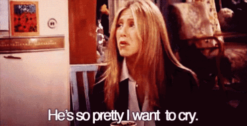 a woman is sitting in a chair and saying `` he 's so pretty , i want to cry . ``