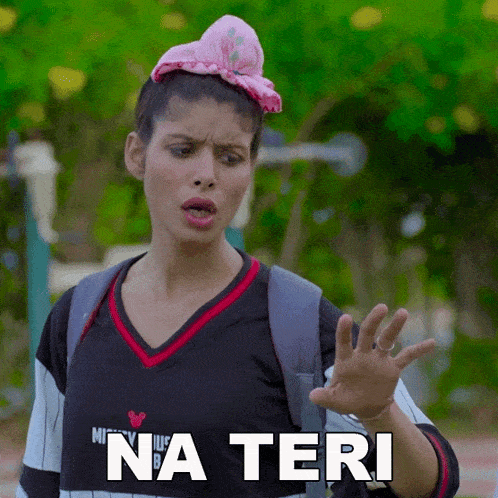a woman wearing a minnie mouse shirt is making a funny face and saying na teri
