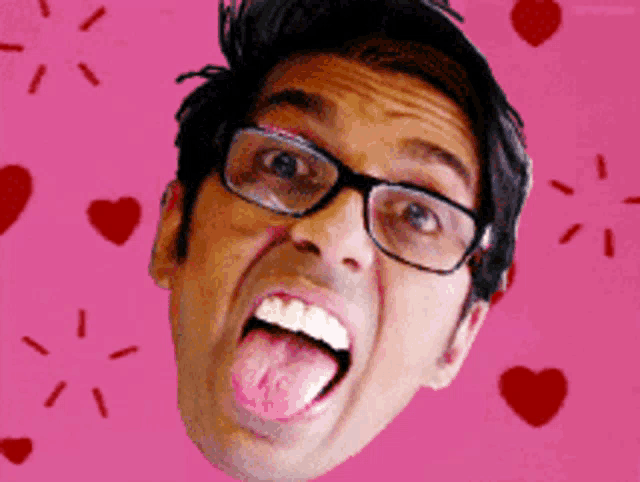 a man with glasses sticking his tongue out in front of hearts