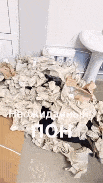 a pile of crumpled paper is on the floor next to a sink