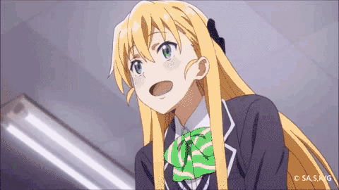 a girl with long blonde hair and green eyes is wearing a school uniform and a green and white bow tie .
