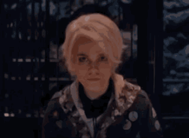a close up of a person 's face with a blurred background .