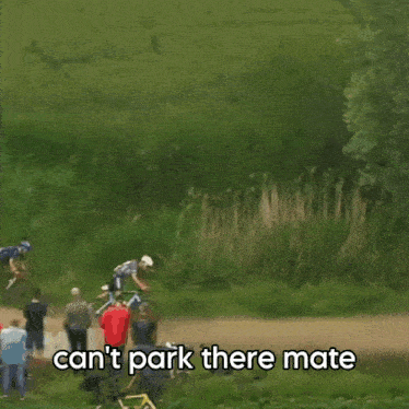 a man riding a bike on a dirt road with the words " can 't park there mate " above him