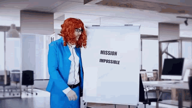 a woman in a blue suit is standing in front of a whiteboard that says mission impossible