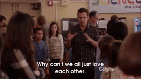 a man talking to a group of people with the words " why can 't we all just love each other " on the bottom