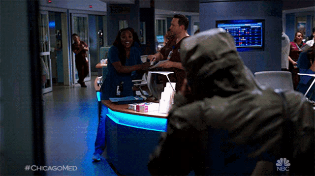 a man in a hooded jacket is standing in a hospital hallway with the hashtag #chicagomed