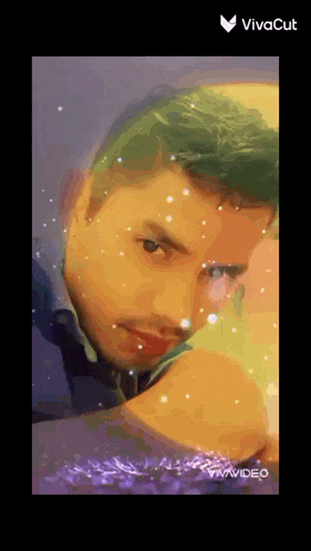 a man with green hair is looking at the camera with a vivacut logo on the bottom right