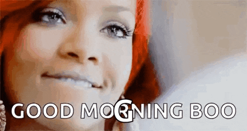 a woman with red hair is smiling with the words `` good morning boo '' written above her .