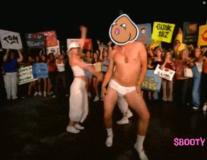 a man and a woman are dancing in front of a crowd holding signs including one that says blink 182