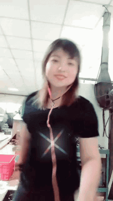 a woman wearing a black shirt with a red x on it